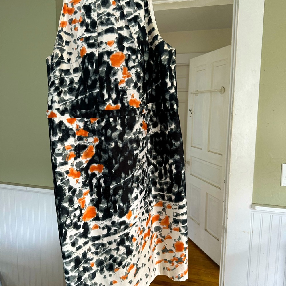 100% Cotton sleeveless lined sheath in size 16. White background w/orange &  bk
